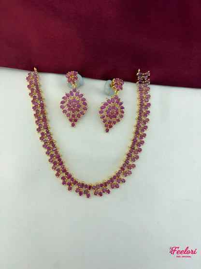 FeelOri Gold Plated Ruby Leaf Cluster Necklace Set - Full front view showcasing the intricate design of both necklace and matching earrings.