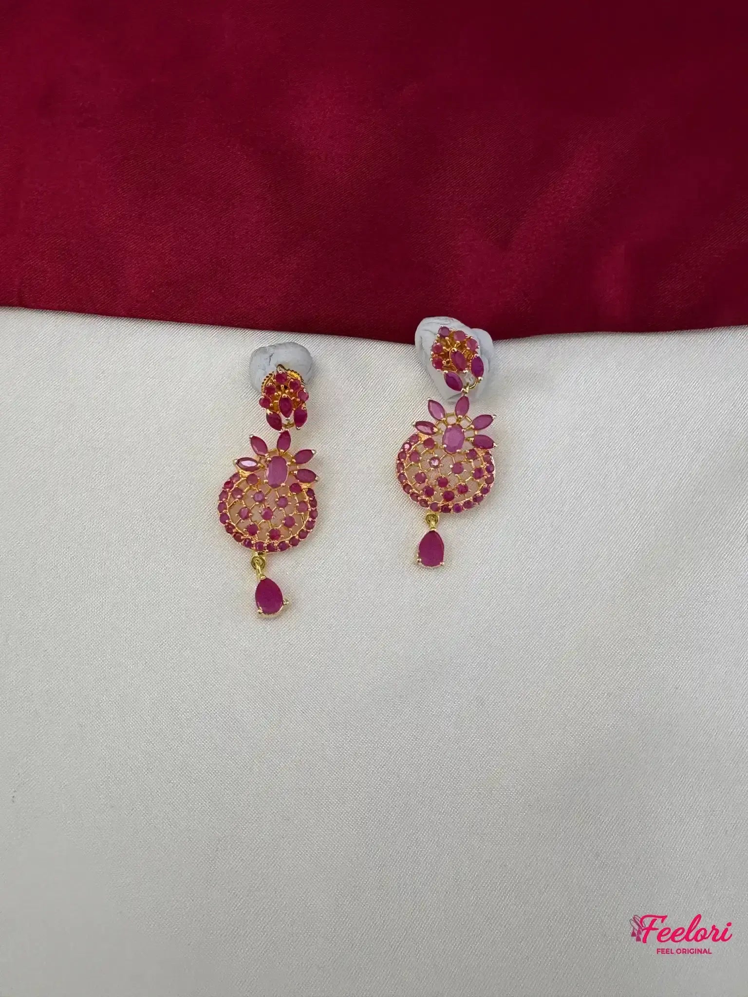 FeelOri Gold Plated Ruby Petal Earrings - Close-up view of the matching earrings featuring a detailed petal-like stone arrangement and elegant ruby teardrop.