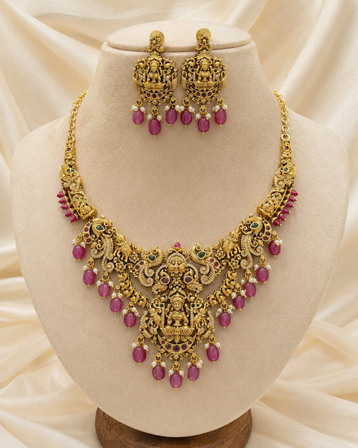 FeelOri ruby-tone necklace set with matching earrings on jewellery display