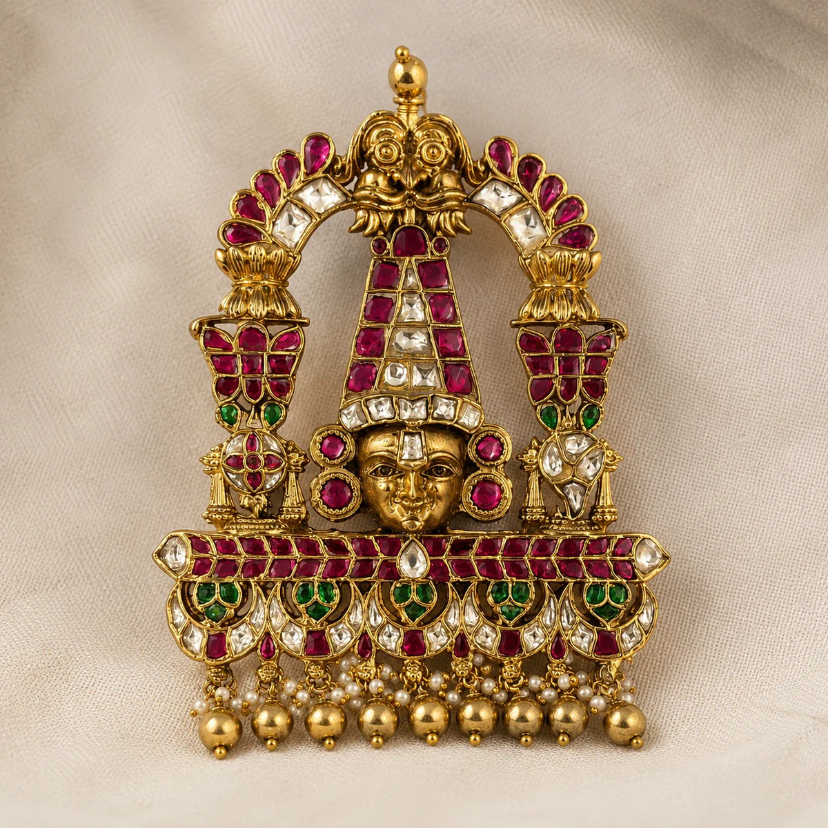Close front view of Tirupati Balaji Jadau Kundan temple pendant showing ruby, green and white stone work