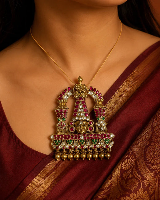 Model wearing the FeelOri Tirupati Balaji Jadau Kundan temple pendant with a maroon silk saree